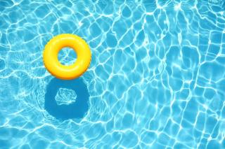 A yellow flotation ring floating in blue water
